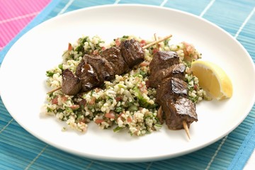 Beef kebabs on a bed of bulgur