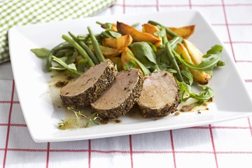 Oven-roasted pork fillet with a spice crust and vegetables