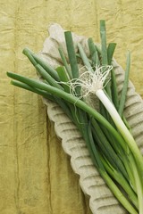 Spring onions in a wooden bowl