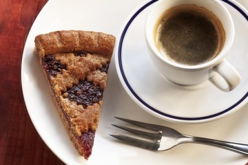 A slice of Linz tart and a cup of espresso