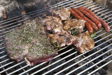 Sausages and steaks on a barbecue