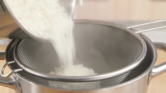 Rice being poured into a pot