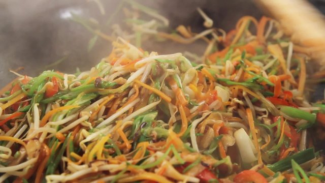 Stir-frying vegetables in a wok