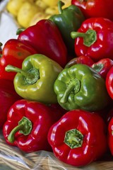 Various different coloured peppers in a basket