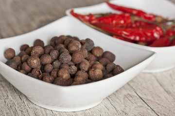 Allspice berry and chilli peppers in a bowl