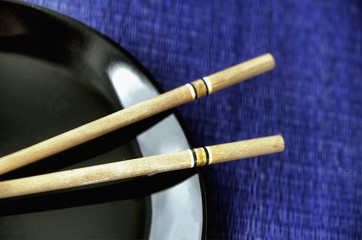 Fototapeta na wymiar Chopsticks on a black plate