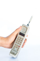 man hand holding vintage mobile phone Isolated on white background.