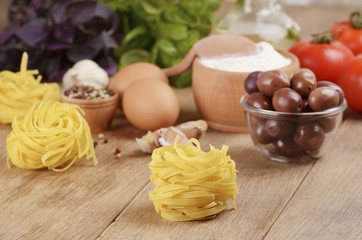 Tagliatelle, eggs, flour, olives, tomatoes and basil
