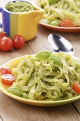 Tagliatelle with pesto, fresh basil and tomatoes