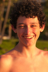 Fototapeta na wymiar Teenage boy at the beach at sunset, Maui, Hawaii, USA