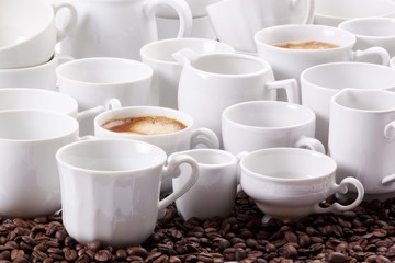 Obraz na płótnie Canvas An arrangement of coffee with hot coffee and white crockery