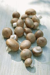 Fresh brown mushrooms on a wooden surface