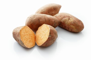 Fototapeta na wymiar Sweet potatoes, whole and halved