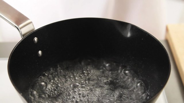 Egg yolk cream being beaten in a bain marie