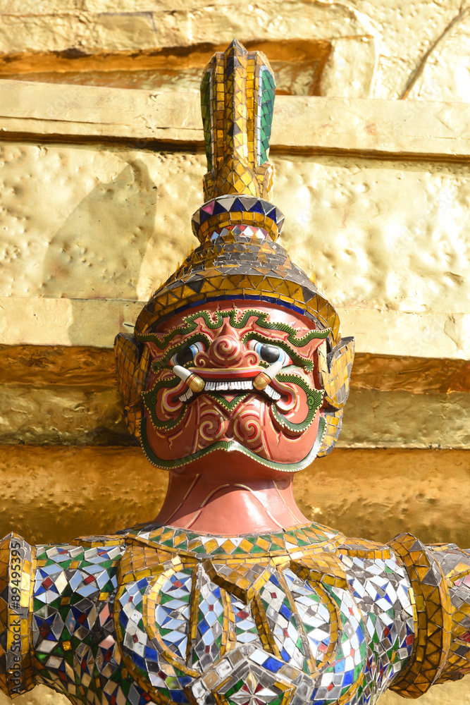 Sticker guardian demon holding golden chedi of wat phra kaew temple in bangkok, thailand