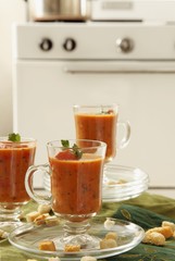 Three Tall Glass Mugs of Creamy Tomato Basil Soup; Croutons