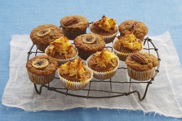 Assorted muffins topped with banana and nuts