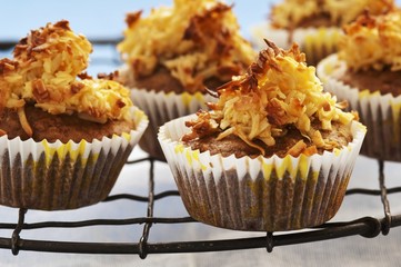 Muffins topped with nuts and coconut