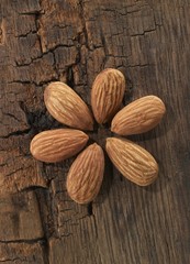 Peeled almonds on a wooden surface