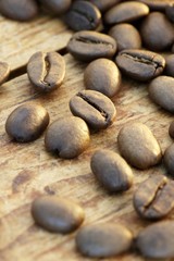 Fototapeta na wymiar Roasted coffee beans on a wooden surface