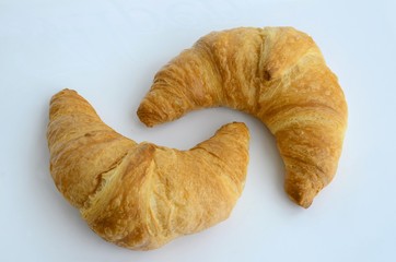 Two croissants against a white background