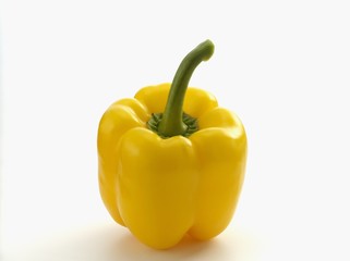 A yellow pepper on a white surface