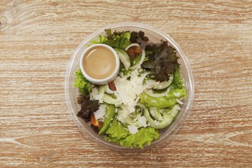 Salad leaves with cucumber, tomatoes, parmesan and cocktail sauce