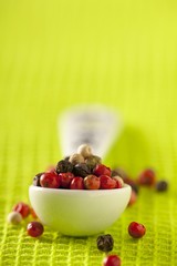 Mixed peppercorns on a spoon