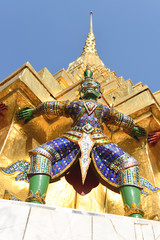 Guardian demon holding Golden Chedi of Wat Phra Kaew Temple in Bangkok, Thailand
