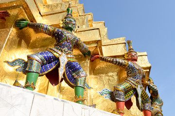 Guardian demon holding Golden Chedi of Wat Phra Kaew Temple in Bangkok, Thailand