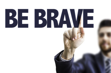 Business man pointing the text: Be Brave