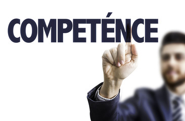 Business man pointing the text: Skills (in French)