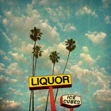 aged and worn vintage photo of liquor sign and palm trees