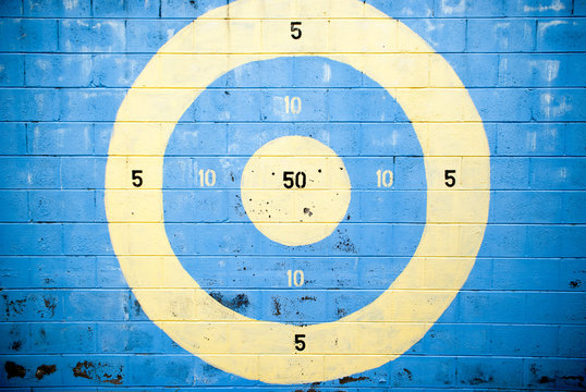 target with numbers painted on a brick wall
