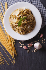 pasta with pesto and parmesan and ingredients. vertical top view
