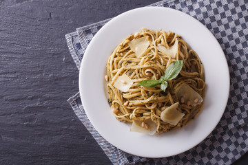 pasta with pesto, pine nuts and parmesan. horizontal top view 
