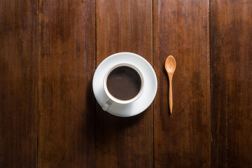 Coffee cup on wooden background, top view
