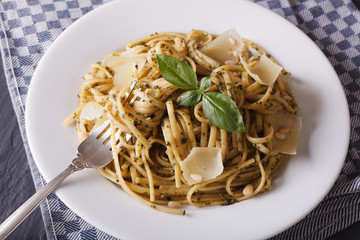 pasta with pesto and parmesan close-up on a plate. horizontal
