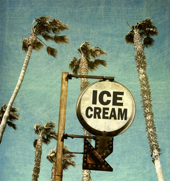 aged and worn vintage photo of ice cream sign and palm trees