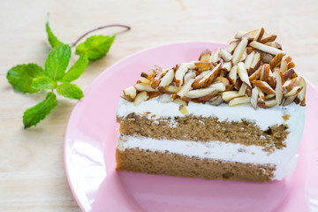 Coffee almond cake delicious with green mint  on dish on table.