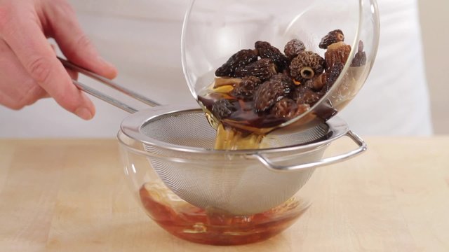Softened black morels being drained
