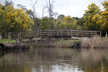 Fototapeta na wymiar a wooden timber bridge over water