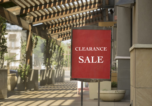Clearance sale sign outside shop in outdoor upscale shopping mall