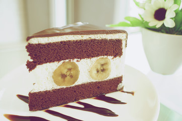 Piece of chocolate with banana cake in vintage style