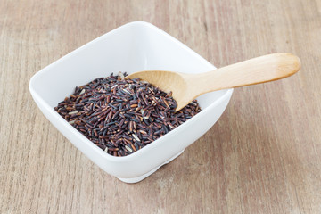 Rice berry, Brown rice in wooden spoon on wood, selective focus