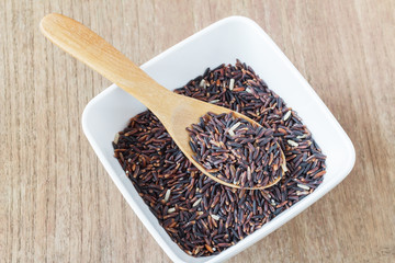 Rice berry, Brown rice in wooden spoon on wood, selective focus