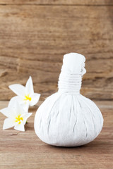 Fototapeta na wymiar Thai herbal compress for spa with white plumeria flower (frangip