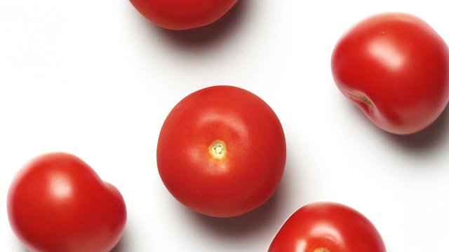 Five tomatoes on a rotating plate