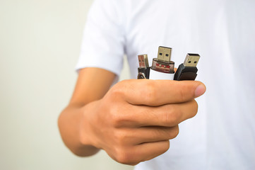 Man hand holding three usb flash