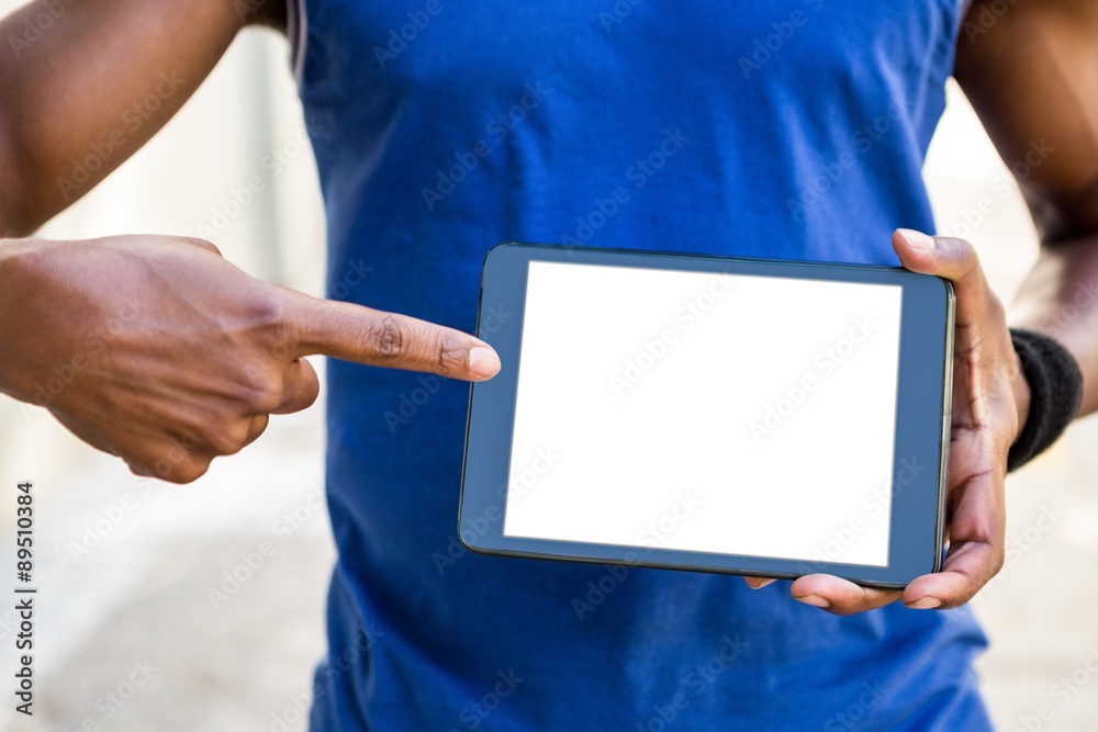 Poster athletic man using tablet computer